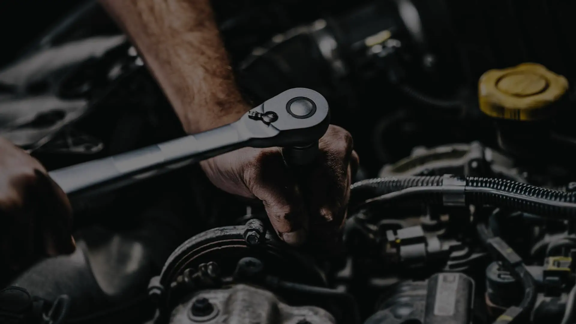 Ratchet tool being used in an engine bay